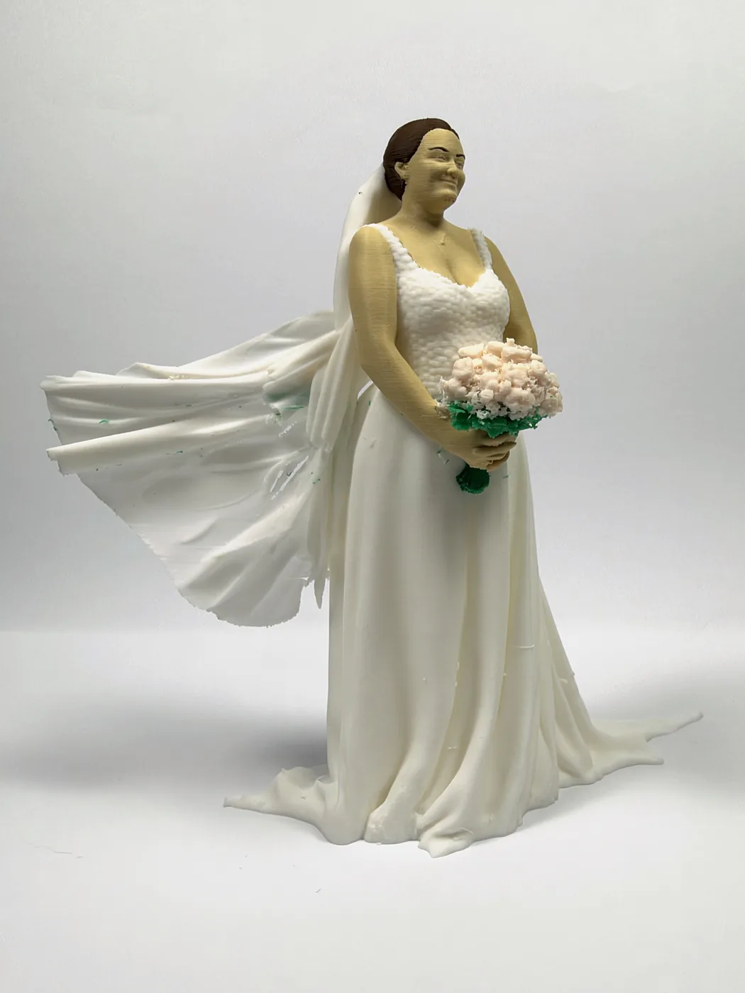 The bride figure from the front, her veil blown out to one side